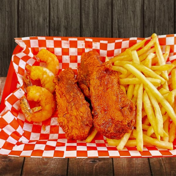 Fried shrimp, chicken tenders, and french fries in a red and white checkered basket.